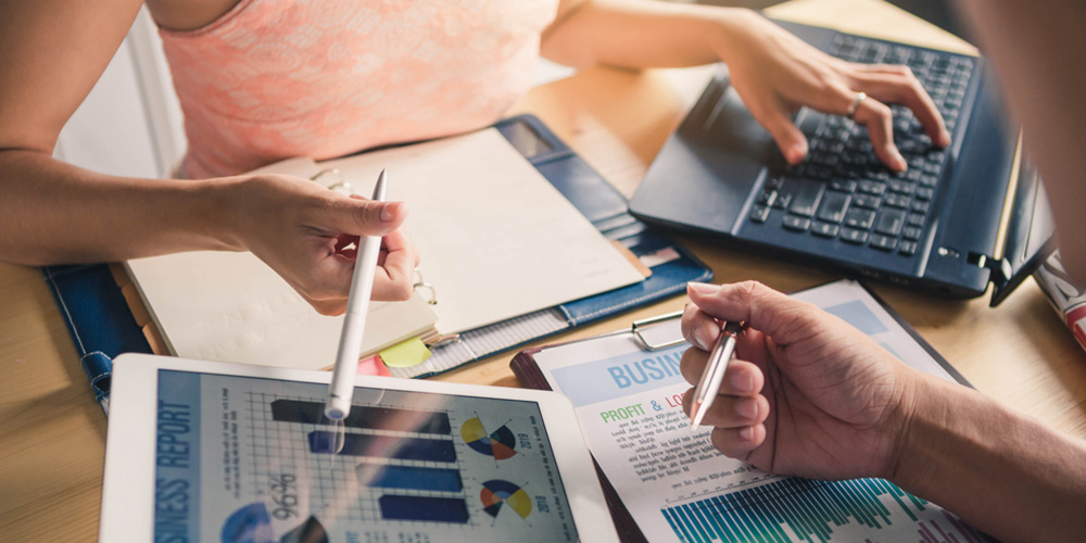 2 people reviewing business reports