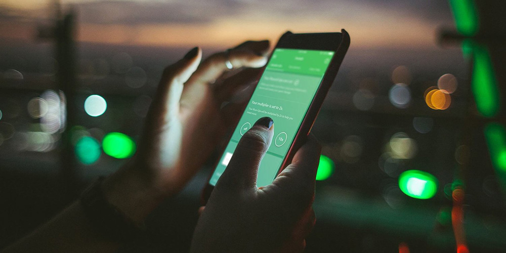 closeup of a woman using Acorn on her phone