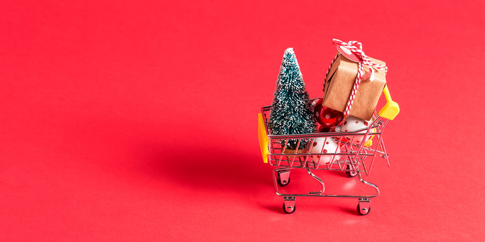 mini shopping cart with presents and a tree