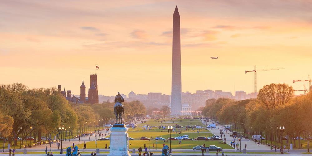 Washington DC city view at a orange sunset, including Washington Monument from Capitol building