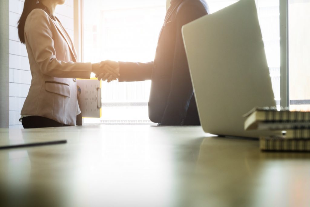 woman and man shaking hands