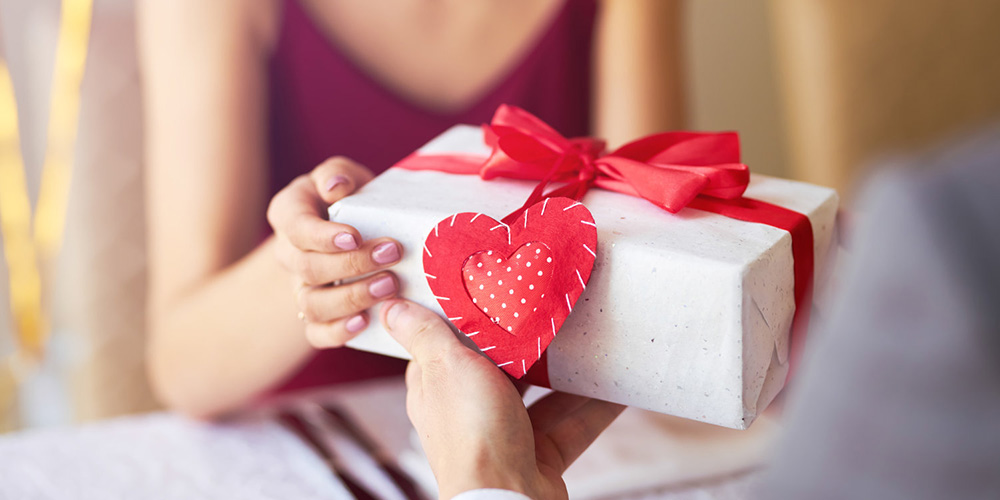 woman receiving a Valentine's Day gift